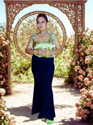 Woman wearing golden satin bow-tie crop top and black flared skirt – elegant partywear outfit by Melegant by LC