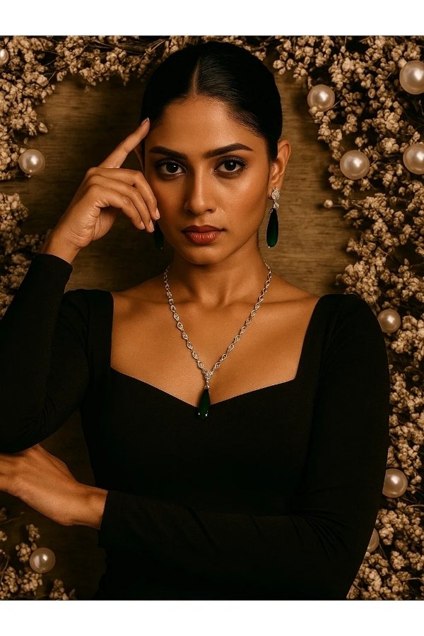 Elegant silver necklace with white stones and green teardrop pendant paired with matching drop earrings