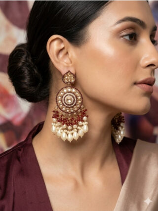 Maroon and gold Kundan Chandbali statement earrings with pearl drops worn by a model in an elegant silk outfit, from Melegant by LC