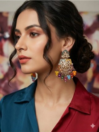 Model showcasing Melegant by LC multi-color enamel Kundan chandelier earrings featuring colorful gemstone beads and orange drop clusters, paired with a teal and maroon color-blocked top