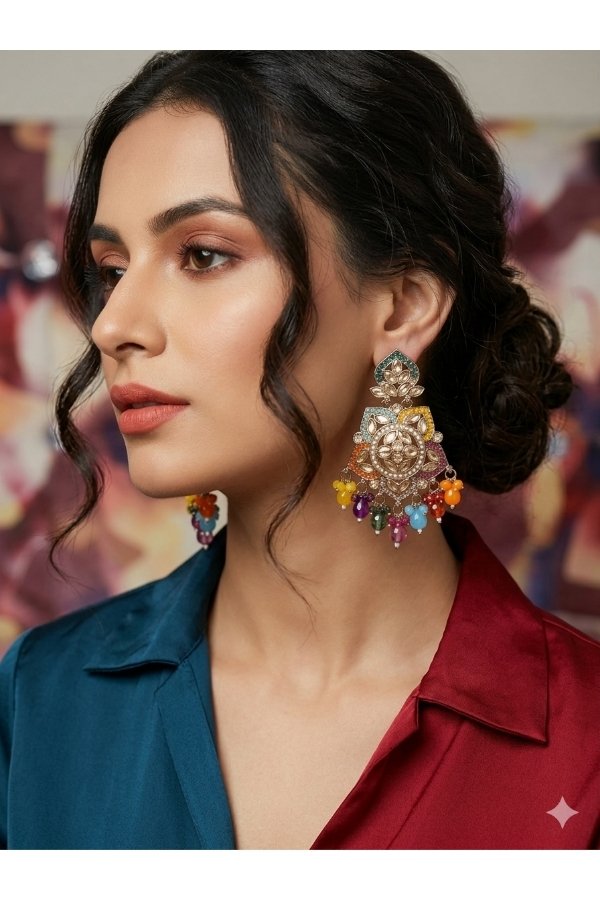 Model showcasing Melegant by LC multi-color enamel Kundan chandelier earrings featuring colorful gemstone beads and orange drop clusters, paired with a teal and maroon color-blocked top