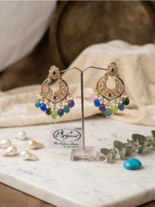 Multi-color gemstone and pearl drop chandbali earrings displayed on a stand with the melegant by lc tag in Ghaziabad
