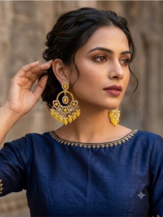Yellow Kundan inspired statement earrings with pearl-style and beaded drops worn with a navy blue ethnic outfit by Melegant, Indirapuram Ghaziabad