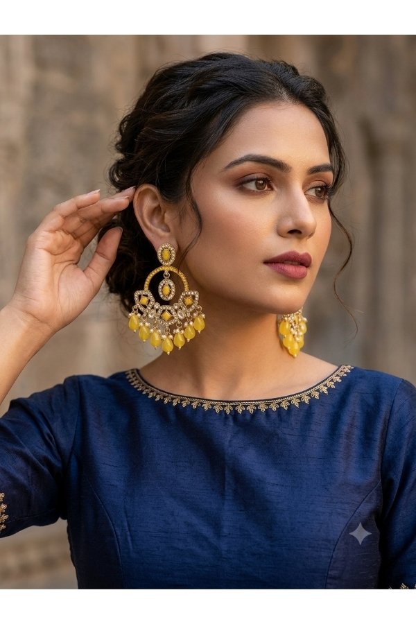 Yellow Kundan inspired statement earrings with pearl-style and beaded drops worn with a navy blue ethnic outfit by Melegant, Indirapuram Ghaziabad