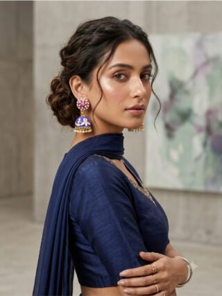 Blue and purple Meenakari enamel jhumka earrings displayed on a stand with an artisanal Meenakari sign for online and in-store shopping at Melegant by LC in Indirapuram Ghaziabad.