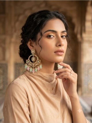 Pastel pink and mint green Kundan chandbali earrings displayed on a stand with Melegant by LC branding card for online shopping.